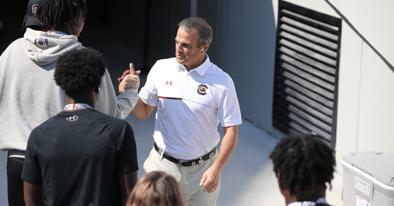 South Carolina head coach Shane Beamer meets with a recruit before the Georgia game