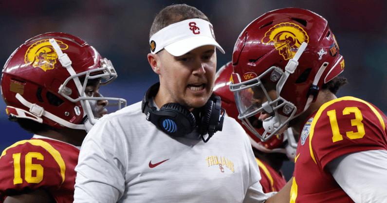 Head coach Lincoln Riley of the USC Trojans talks with quarterback Caleb Williams #13 during action against the Tulane Green Wave in the second half of the Goodyear Cotton Bowl Classic on January 2, 2023 at AT&T Stadium in Arlington, Texas. Tulane won 46-