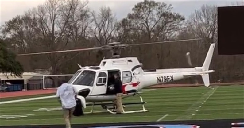 Miami coach Mario Cristobal arrives via helicopter at high school