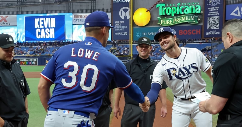 Tampa Bay Rays' Josh Lowe, left, tugs on the jersey of his brother Texas  Rangers' Nathaniel Lowe after flying out during the seventh inning of a  baseball game Sunday, June 11, 2023