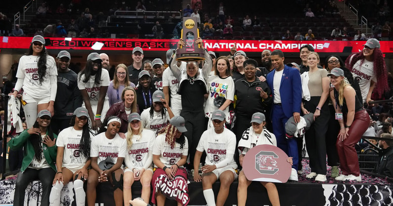 South Carolina Gamecocks head coach Dawn Staley celebrates with the trophy after defeating the Iowa Hawkeyes in the finals of the Final Four of the womens 2024 NCAA Tournament at Rocket Mortgage FieldHouse. Mandatory Credit: Kirby Lee-USA TODAY Sports