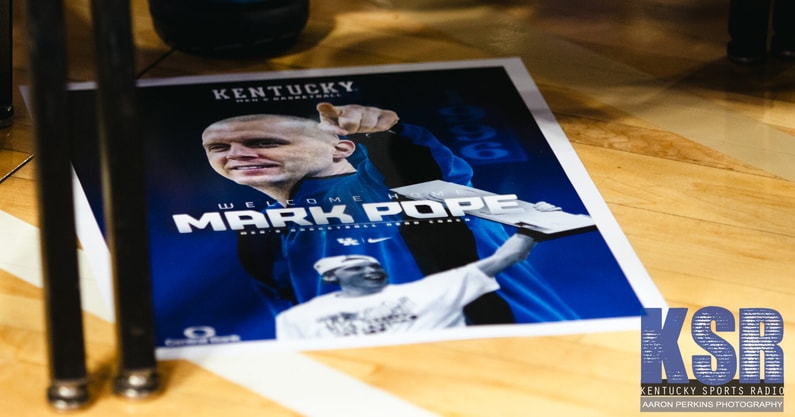 A commemorative Mark Pope print at his introductory press conference - Aaron Perkins, Kentucky Sports Radio