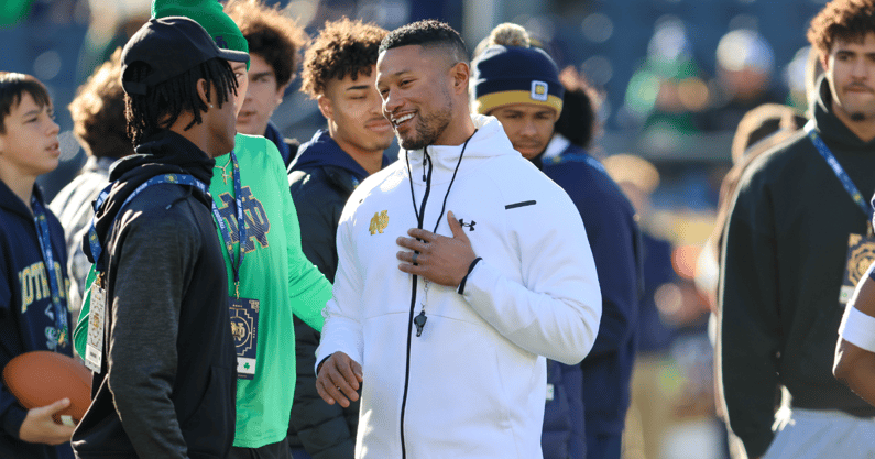 Notre Dame coach Marcus Freeman (center) talks to recruits before a game during the 2023 season. (Chad Weaver/Blue & Gold)