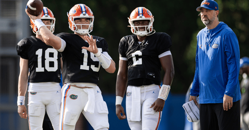 Florida Gators quarterback Graham Mertz (15) throws the ball while Florida Gators offensive analyst for quarterbacks Ryan O'Hara and Florida Gators quarterback DJ Lagway (2) watch during spring football practice at Heavener Football Complex at the University of Florida in Gainesville, FL on Tuesday, April 2, 2024. [Matt Pendleton/Gainesville Sun]