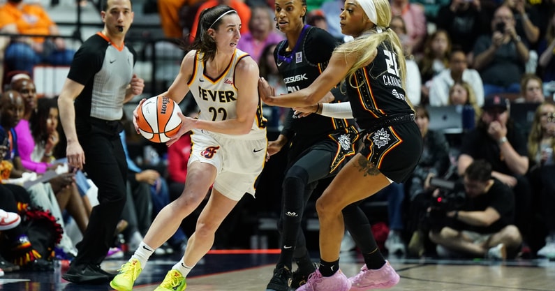Indiana Fever guard Caitlin Clark (22) moves the ball against Connecticut Sun guard DiJonai Carrington (21). (Photo by David Butler II-USA Today)