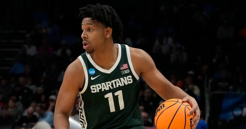 Michigan State Spartans guard A.J. Hoggard (11) controls the ball against the Mississippi State Bulldogs in the first round of the 2024 NCAA Tournament at the Spectrum Center. - Jim Dedmon, USA Today Sports