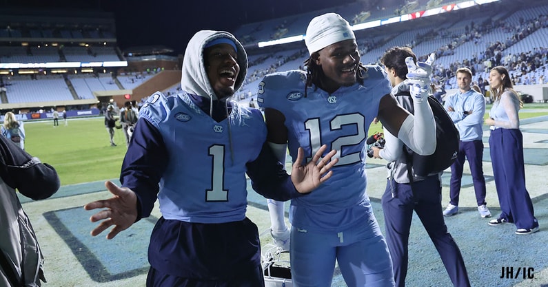 UNC's Thad Dixon and Greg Smith walking off the field.