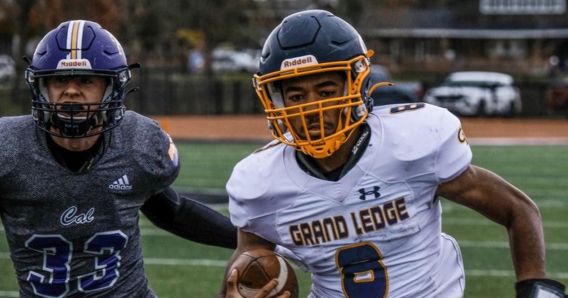 Michigan State walk-on and former Grand Ledge quarterback Shawn Foster (8) gets some running room ahead of Caledonia's Theren Sanders (33) in the Regional Final Saturday, Nov. 12, 2022. - Robert Killips, USA TODAY Sports