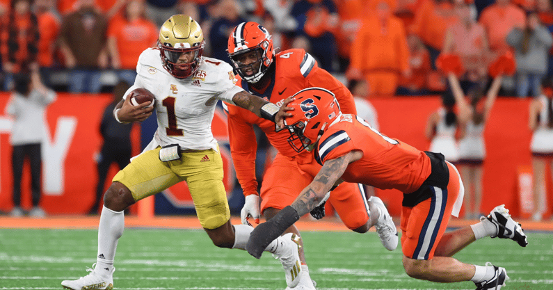 Nov 3, 2023; Syracuse, New York, USA; Boston College Eagles quarterback Thomas Castellanos (1) runs with the ball as Syracuse Orange defensive lineman Caleb Okechukwu (4) and defensive back Justin Barron (8) give chase during the second half at the JMA Wireless Dome. Mandatory Credit: Rich Barnes-USA TODAY Sports