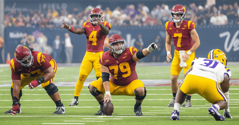 USC center Jonah Monheim points to an LSU defender as the Trojans get set to snap the ball