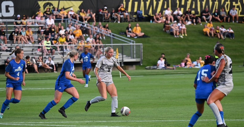 Iowa forward Berit Parten dribbles the ball against the FGCU defense. (Photo by Dennis Scheidt)