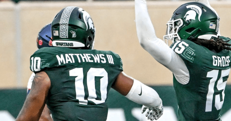 Michigan State's Angelo Grose, center celebrates his interception against Florida Atlantic with teammates Wayne Matthews III, left, and Nikai Martinez during the second quarter - Nick King, USA TODAY Sports