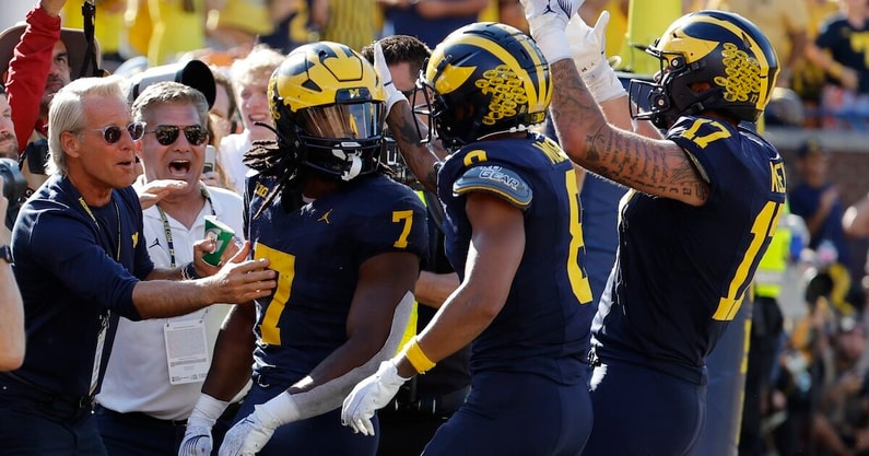 Michigan Wolverines running back Donovan Edwards (7) receives congratulations from teammates after he rushes for a touchdown in the first half against the USC Trojans at Michigan Stadium. Mandatory Credit: Rick Osentoski-Imagn Images