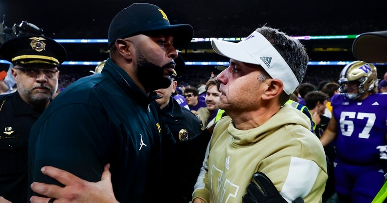 Oct 5, 2024; Seattle, Washington, USA; Michigan Wolverines head coach Sherrone Moore, left, shakes hands with Washington Huskies head coach Jedd Fisch, right, following a Washington victory at Alaska Airlines Field at Husky Stadium. Mandatory Credit: Joe Nicholson-Imagn Images