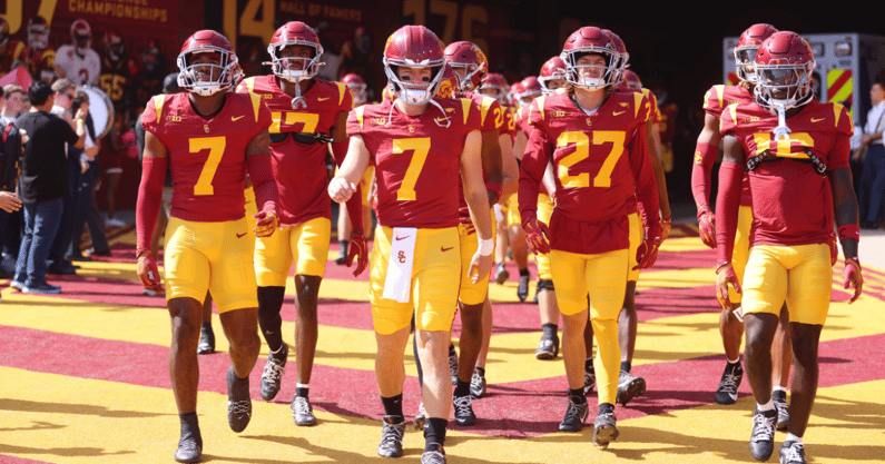 The USC Trojans, led by quarterback Miller Moss, walk out of the Coliseum tunnel before a game against the Penn State Nittany Lions