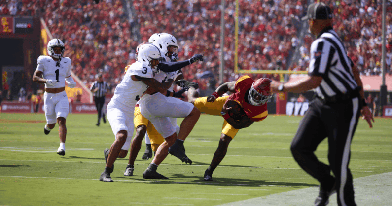 USC running back Woody Marks gets tackled by Penn State defenders during a game between the Trojans and Nittany Lions