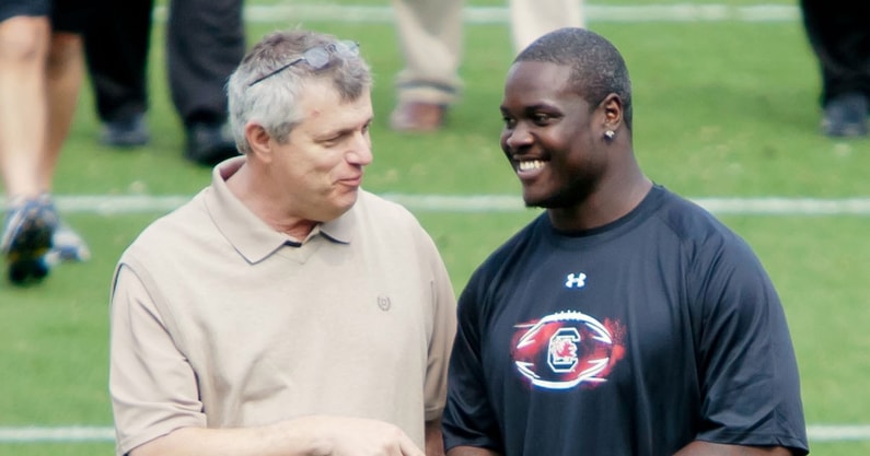 March 28, 2012; Columbia, SC, USA; South Carolina athletic director Eric Hyman (left) speaks with defensive end Melvin Ingram during the South Carolina pro day at Williams-Brice Stadium. Mandatory Credit: Jeff Blake-USA TODAY Sports