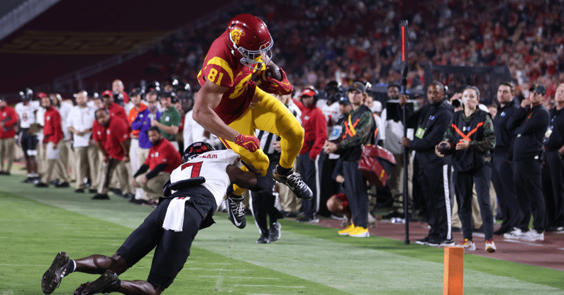 USC wide receiver Kyle Ford goes up and over a Rutgers defender into the endzone for a touchdown