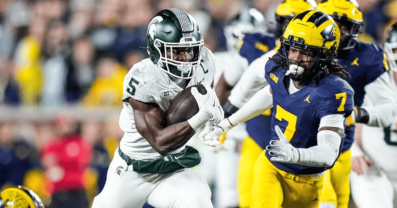 Michigan State running back Nate Carter (5) runs against Michigan defensive back Makari Paige (7) during the first half at Michigan Stadium in Ann Arbor on Saturday, Oct. 26, 2024 - Junfu Han, USA TODAY Sports