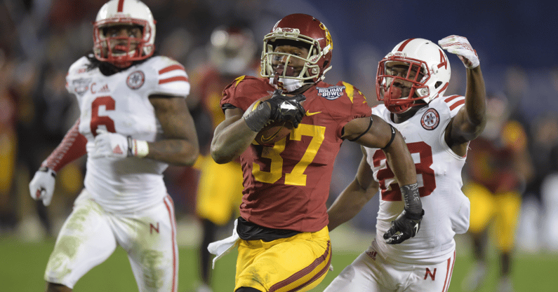 USC Trojans tailback Javorius Allen (37) is pursued by Nebraska Cornhuskers linebacker Austin Williams (24) on a 44-yard touchdown run in the third quarter in the 2014 Holiday Bowl at Qualcomm Stadium