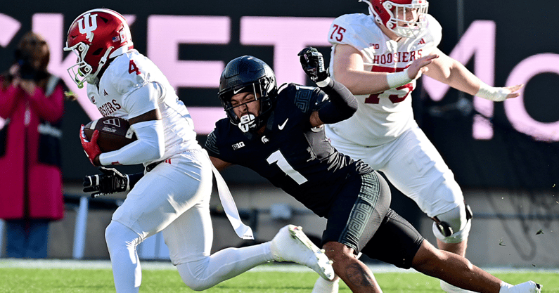 Indiana Hoosiers wide receiver Myles Price (4) runs away from Michigan State Spartans defensive back Nikai Martinez (1) during the second quarter at Spartan Stadium. - Dale Young, USA TODAY Sports