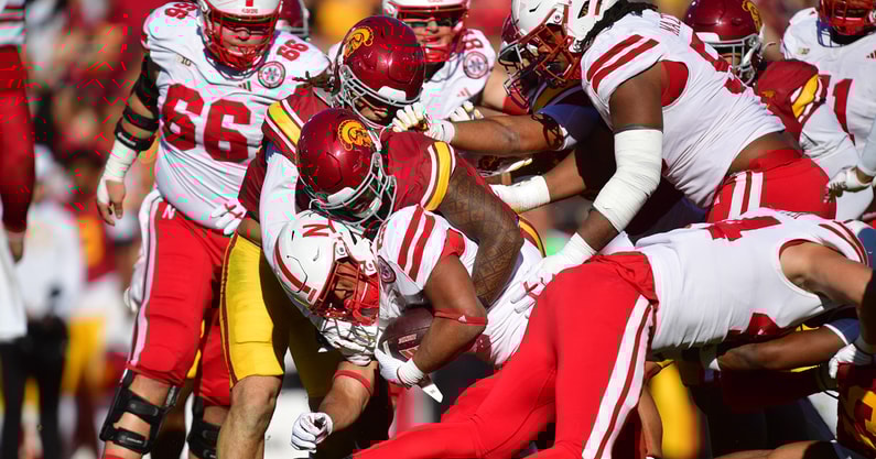 Nebraska Cornhuskers running back Dante Dowdell (23) is brought down against the Southern California Trojans defense during the first half at the Los Angeles Memorial Coliseum