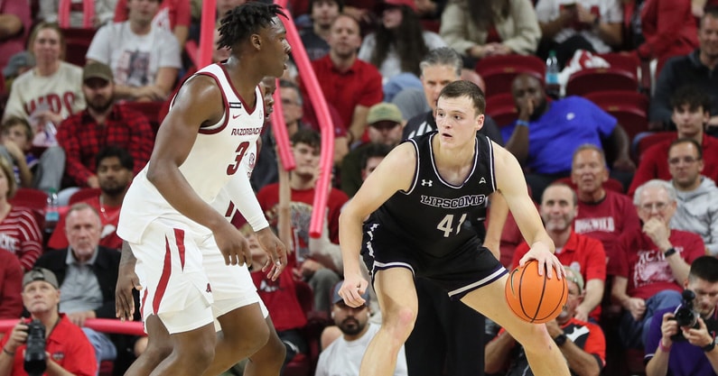 Nov 6, 2024; Fayetteville, Arkansas, USA; Lipscomb Bisons forward Jacob Ognacevic (41) drives against Arkansas Razorbacks forward Adou Thiero (3) in the second half at Bud Walton Arena. Arkansas won 76-60. Mandatory Credit: Nelson Chenault-Imagn Images