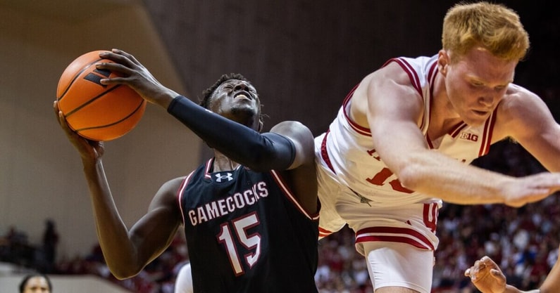 Nov 16, 2024; Bloomington, Indiana, USA; South Carolina basketball guard Morris Ugusuk (15) shoots the ball while Indiana Hoosiers guard James Goodis (15) defends in the second half at Simon Skjodt Assembly Hall. Mandatory Credit: Trevor Ruszkowski-Imagn Images