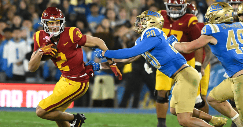 USC Trojans wide receiver Duce Robinson (2) tries to run past UCLA Bruins linebacker Kain Medrano (20) during the second quarter at Rose Bowl