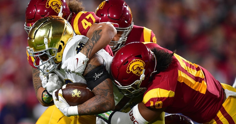 Notre Dame Fighting Irish wide receiver Avery Davis (3) is brought down by USC Trojans defensive lineman Stanley Ta'ufo'ou (47) and linebacker Ralen Goforth (10) during the first half at the Los Angeles Memorial Coliseum