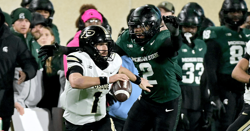 Purdue Boilermakers quarterback Hudson Card (1) scrambles, under pressure from Michigan State Spartans defensive lineman Khris Bogle (2) during the third quarter at Spartan Stadium. - Dale Young, USA TODAY Sports