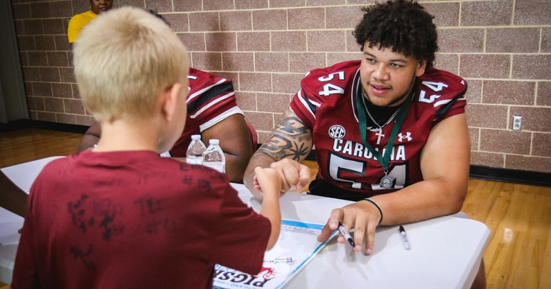 South Carolina offensive lineman Kam Pringle signing an autograph for a young fan. Photo by: Katie Dugan | GamecockCentral