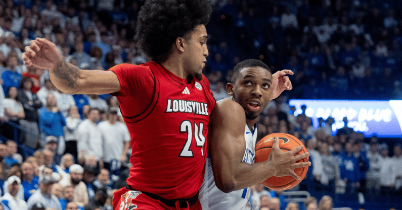 Kentucky Wildcats guard Lamont Butler (1) is fouled by Louisville Cardinals guard Chucky Hepburn (24) during their game on Saturday, Dec. 14, 2024 at Rupp Arena in Lexington, Ky.