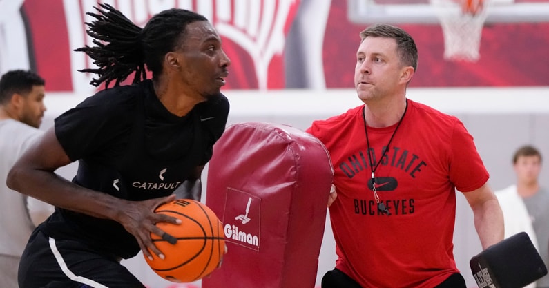 Jul 9, 2024; Columbus, OH, USA; Ohio State Buckeyes head coach Jake Diebler uses pads to defend forward Aaron Bradshaw during a summer workout in the practice gym at the Schottenstein Center. (© Adam Cairns/Columbus Dispatch / USA TODAY NETWORK)