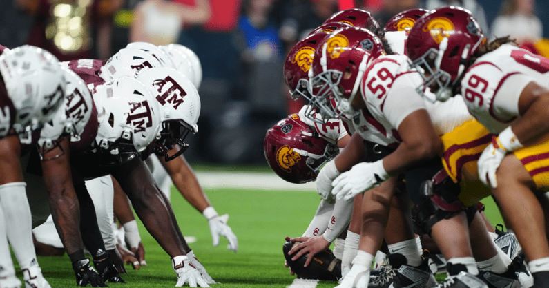 Helmets at the line of scrimmage as USC Trojans long snapper Hank Pepper (31) snaps the ball against the Texas A&M Aggies at Allegiant Stadium