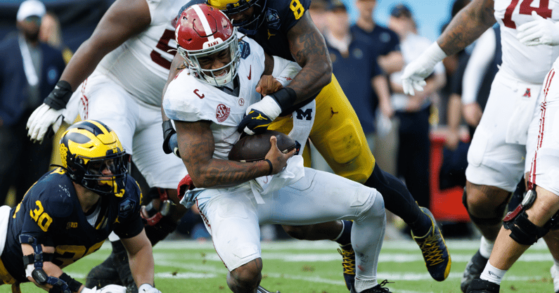 Dec 31, 2024; Tampa, FL, USA; Michigan Wolverines defensive end Derrick Moore (8) sacks Alabama Crimson Tide quarterback Jalen Milroe (4) during the first half at Raymond James Stadium. Mandatory Credit: Matt Pendleton-Imagn Images