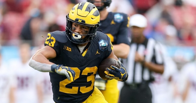 Dec 31, 2024; Tampa, FL, USA; Michigan Wolverines running back Jordan Marshall (23) runs with the ball against the Alabama Crimson Tide in the first quarter during the ReliaQuest Bowl at Raymond James Stadium. Mandatory Credit: Nathan Ray Seebeck-Imagn Images