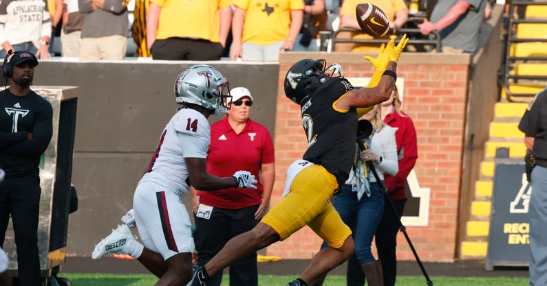 Appalachian State Mountaineers wide receiver Kaedin Robinson (2) catches the ball in front of Troy Trojans cornerback Caleb Ransaw (14) during the second half at Kidd Brewer Stadium