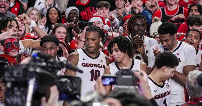 Jan 7, 2025; Athens, Georgia, USA; Georgia Bulldogs players jump into the stands to interact with fans after Georgia defeated the Kentucky Wildcats at Stegeman Coliseum. Mandatory Credit: Dale Zanine-Imagn Images