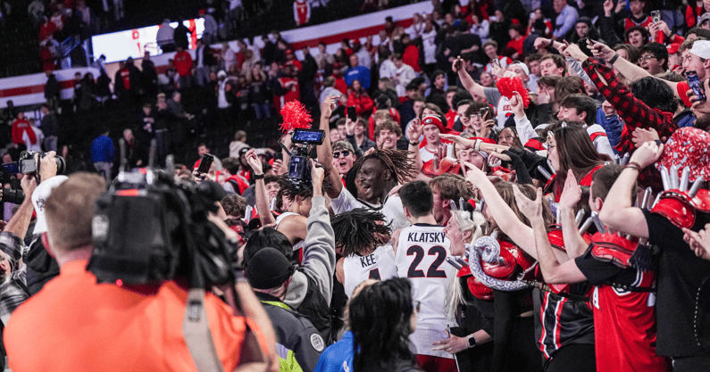 Georgia Bulldogs players jump into the stands to interact with fans after Georgia defeated the Kentucky Wildcats at Stegeman Coliseum - Dale Zanine, Imagn Images