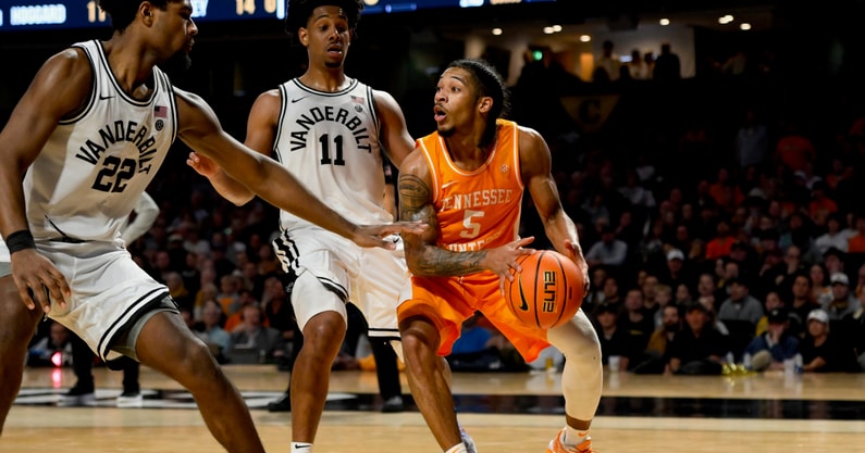 Zakai Zeigler, Tennessee Basketball | (Steve Roberts-Imagn Images) Jan 18, 2025; Nashville, Tennessee, USA; Tennessee Volunteers guard Zakai Zeigler (5) drives the baseline against Vanderbilt Commodores forward Jaylen Carey (22) and guard AJ Hoggard (11) during the second half at Memorial Gymnasium.