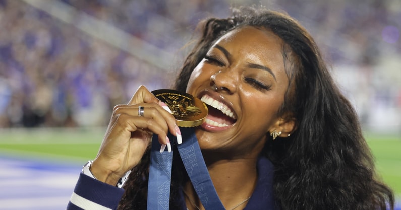 Former Kentucky track star Masai Russell bites her Olympic gold medal at the Georgia game - Dr. Michael Huang, Kentucky Sports Radio