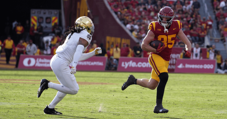 USC Trojans tight end Walker Lyons (85) carries the ball against Notre Dame Fighting Irish safety Xavier Watts (0) in the second half at United Airlines Field at Los Angeles Memorial Coliseum