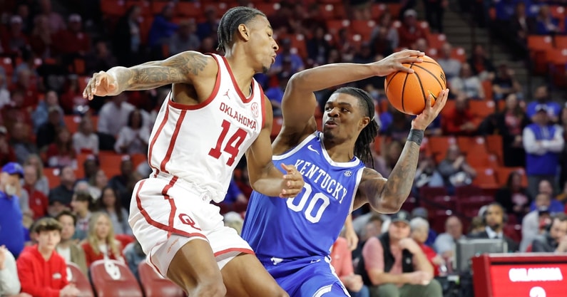Feb 26, 2025; Norman, Oklahoma, USA; Oklahoma Sooners forward Jalon Moore (14) defends a drive by Kentucky Wildcats guard Otega Oweh (00) during the first half at Lloyd Noble Center. Mandatory Credit: Alonzo Adams-Imagn Images
