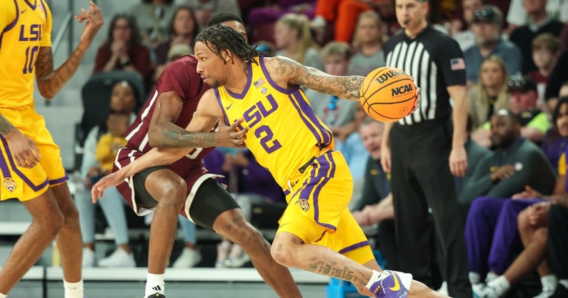 Mar 1, 2025; Starkville, Mississippi, USA; LSU Tigers guard Mike Williams III (2) drives against Mississippi State Bulldogs guard Shawn Jones Jr. (5) during the second half at Humphrey Coliseum. Mandatory Credit: Wesley Hale-Imagn Images