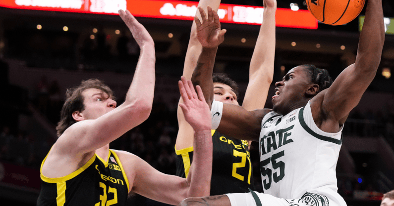 Michigan State Spartans forward Coen Carr (55) goes in for a lay-up against Oregon Ducks center Nate Bittle (32) on Friday, March 14, 2025, during the third round of the men's Big Ten Tournament - Grace Hollars, USA TODAY Sports