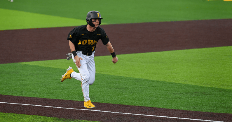 Iowa infielder Gable Mitchell scores a run against Michigan State. (Photo by Dennis Scheidt)