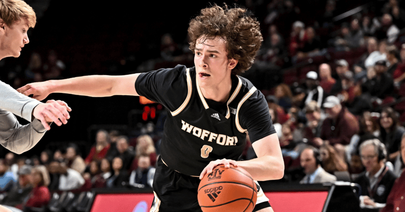 Dec 20, 2022; College Station, Texas, USA; Wofford Terriers guard Jackson Sivills (0) drives to the basket as Texas A&M Aggies guard Hayden Hefner (2) defends during the first half at Reed Arena. Mandatory Credit: Maria Lysaker-Imagn Images