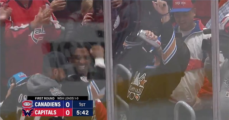 Sam Hartman chugs a beer at a Capitals game as Jayden Daniels and Marcus Mariota cheer him on