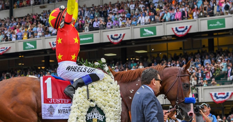 Mike Smith celebrates a Triple Crown win aboard Justify in 2018, via Dennis Schneidler-Imagn Images
